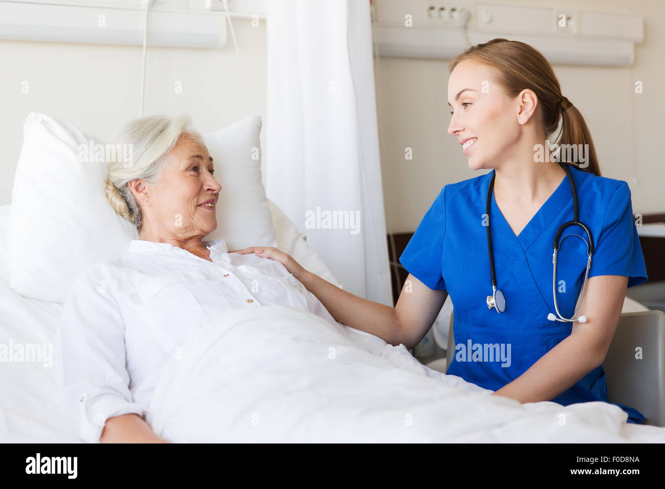 doctor or nurse visiting senior woman at hospital Stock Photo - Alamy