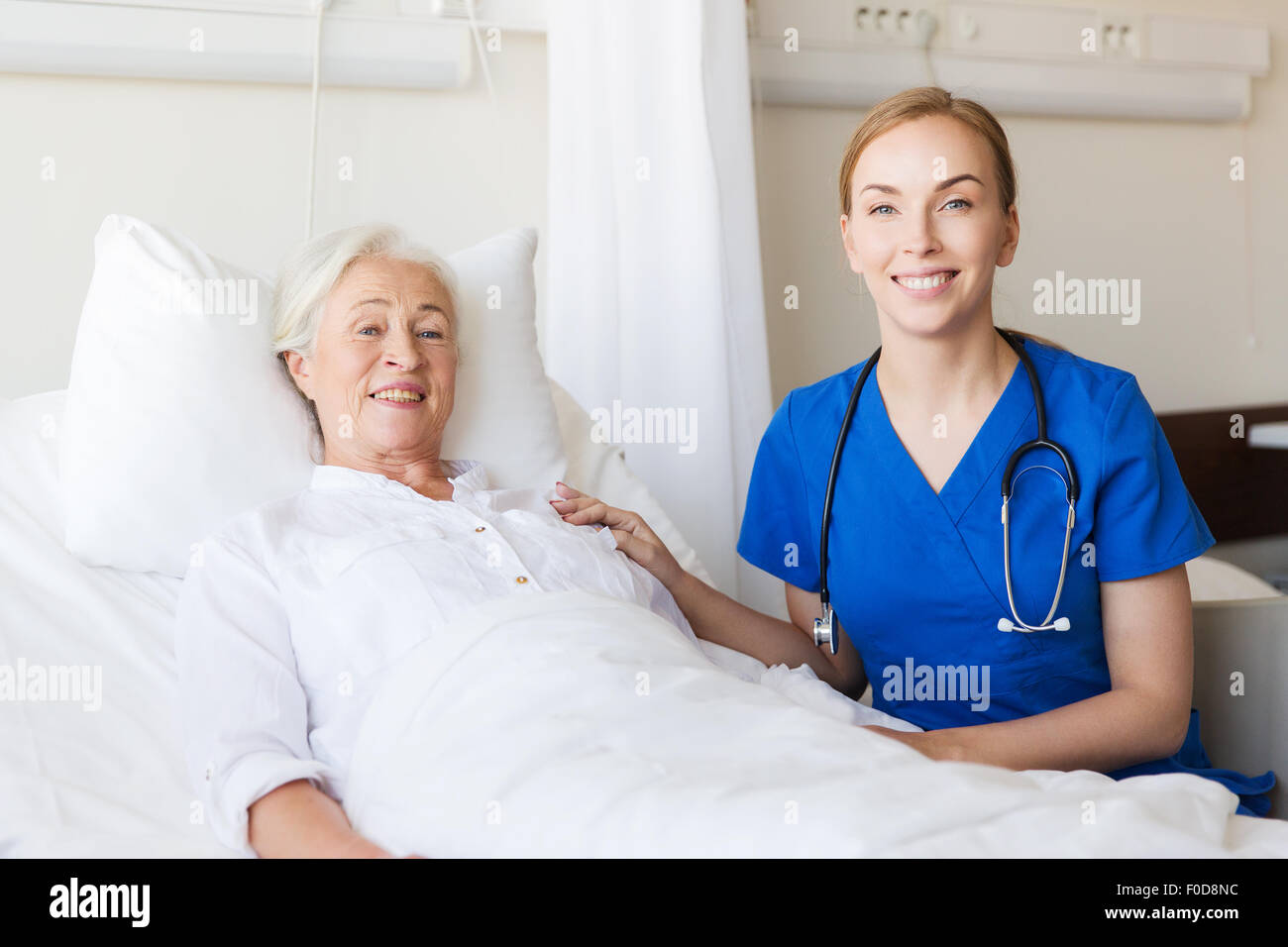 doctor or nurse visiting senior woman at hospital Stock Photo - Alamy