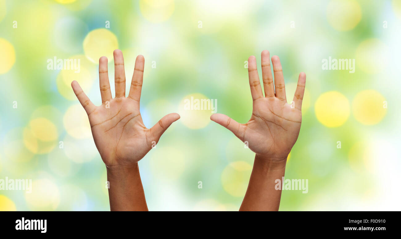 african hands making high five over green lights Stock Photo