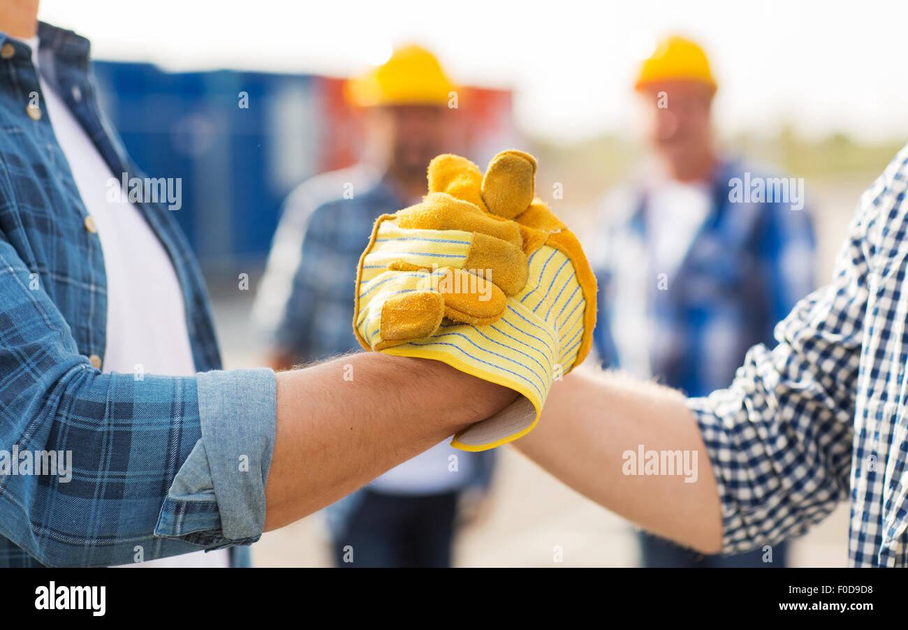 close up of builders hands making handshake Stock Photo