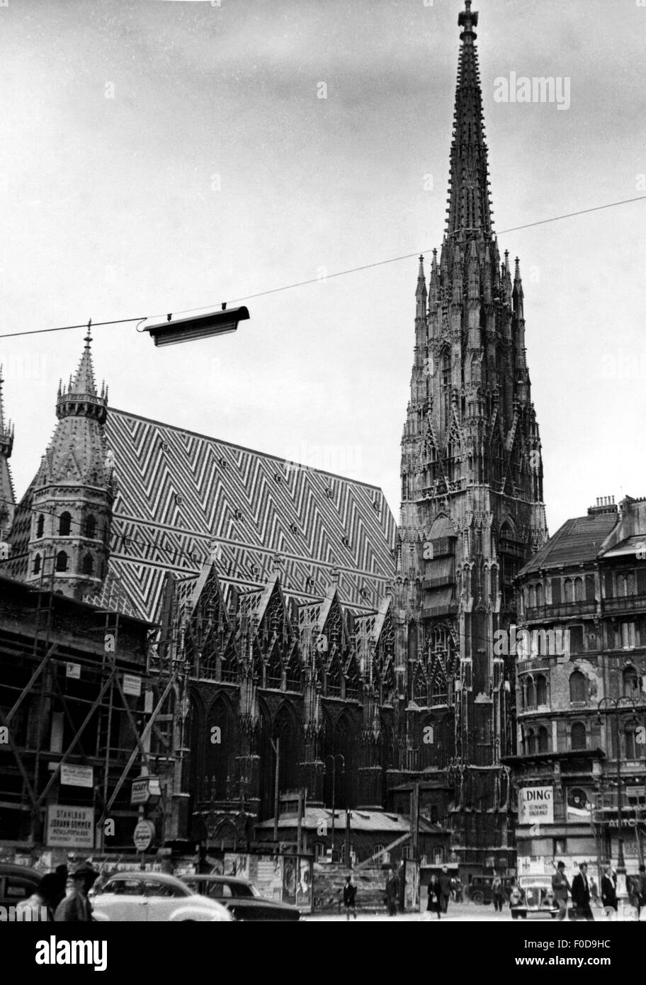 geography / travel,Austria,Vienna,churches,St. Stephen's Cathedral(Stephansdom),built 1137 - 1263,exterior view,circa 1950,Europe,churches,St.,Saint,Stephen,church,cathedrals,exterior view,transport,transportation,street,streets,car,cars,street scene,street scenes,passer-by,passerby,passers-by,pedestrian,pedestrians,street lamp,street lamps,street lighting,20th century,postwar period,post war period,post-war period,post-war years,post-war era,Gothic style,Gothic period,Gothic,historic,historical,1940s,1950s,middle a,Additional-Rights-Clearences-Not Available Stock Photo