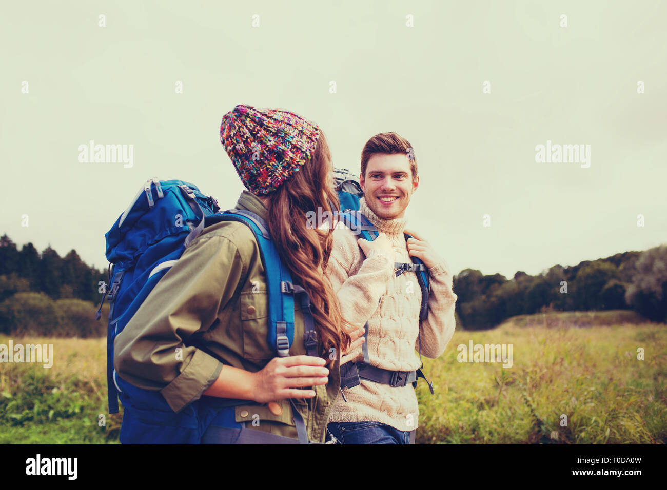 smiling couple with backpacks hiking Stock Photo