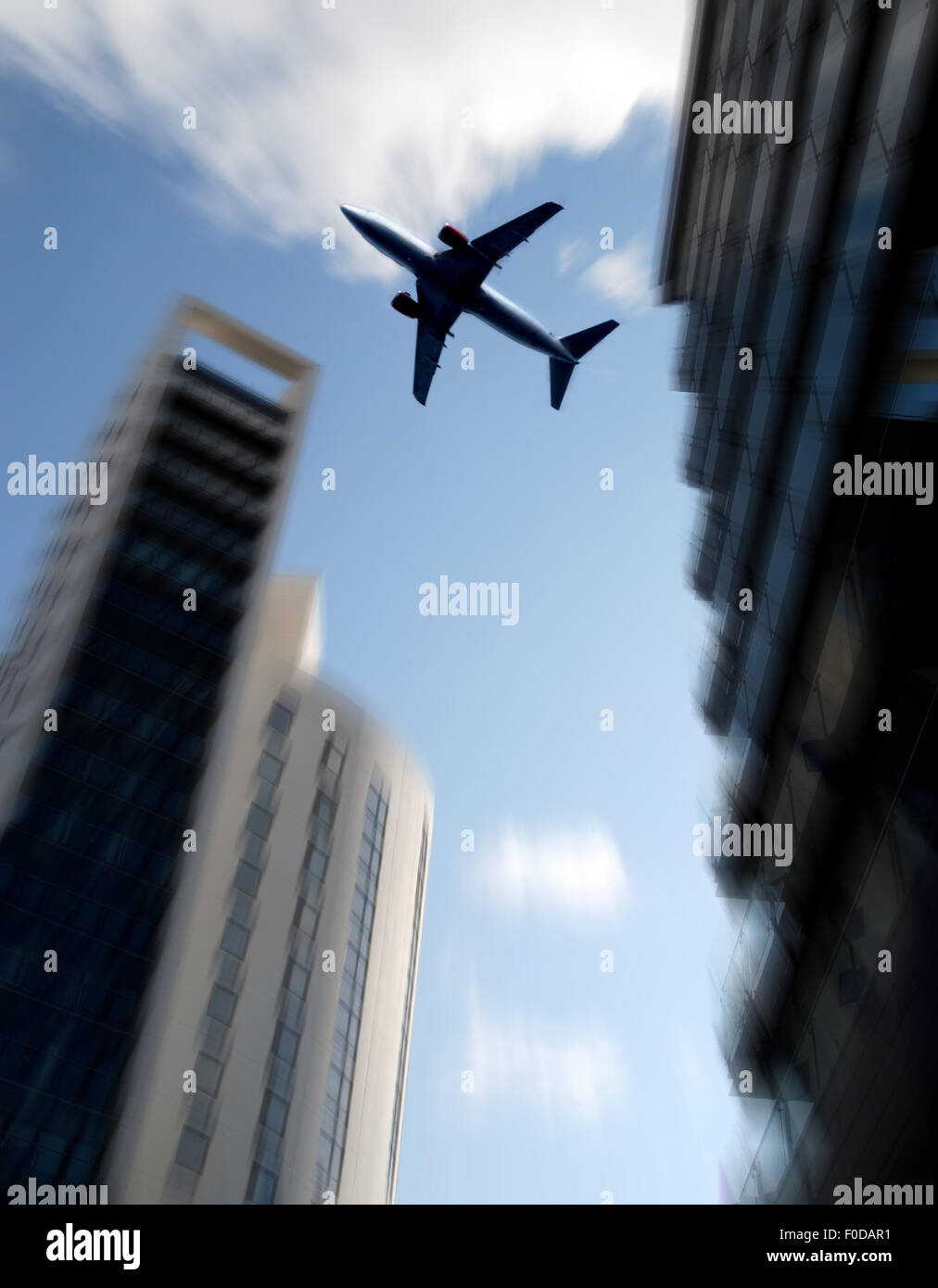 Aircraft flies over tower blocks Stock Photo Alamy
