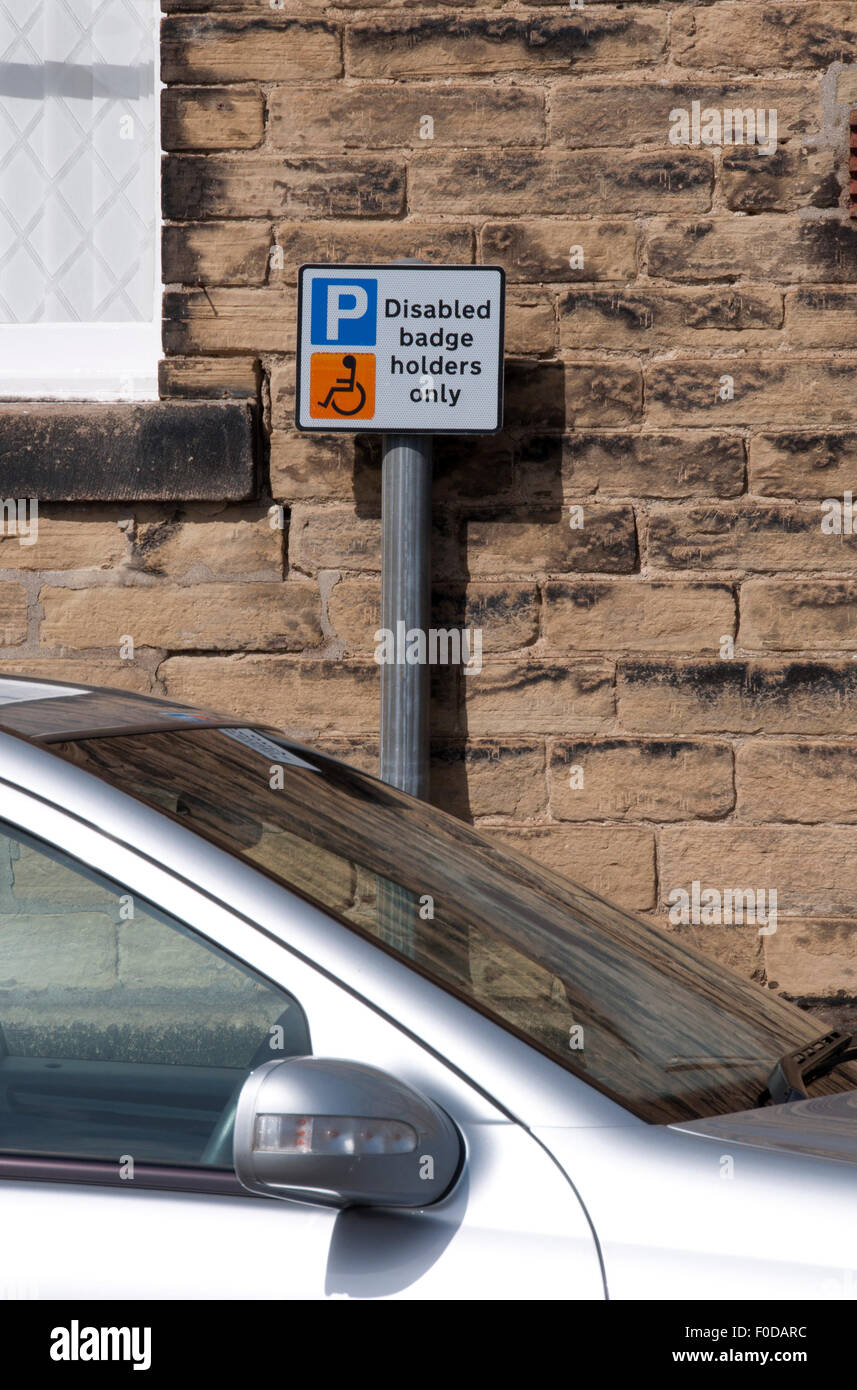 Disabled badge holders parking sign behind parked car Stock Photo Alamy