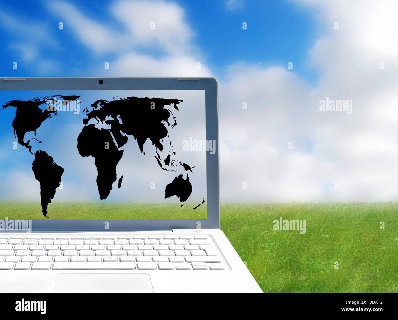 World ouline map on laptop screen over outdoor scene Stock Photo