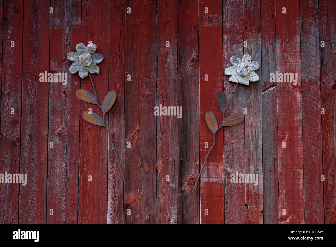 Decorative flowers on red barn door, St. Paul d'Abbotsford, Eastern Townships, Quebec, Canada Stock Photo