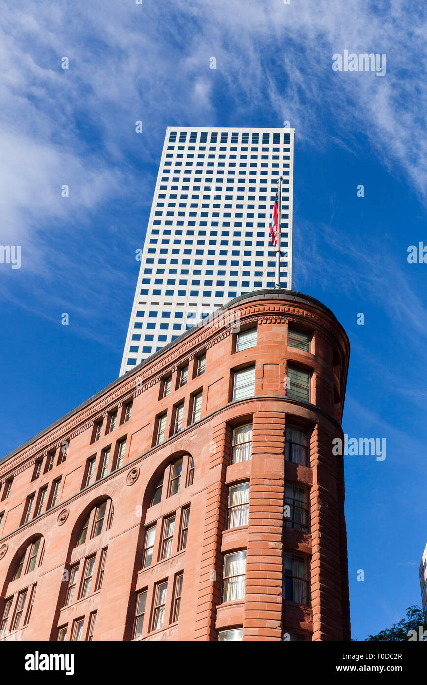 Old red brick hotel with modern office block Denver Colorado USA Stock