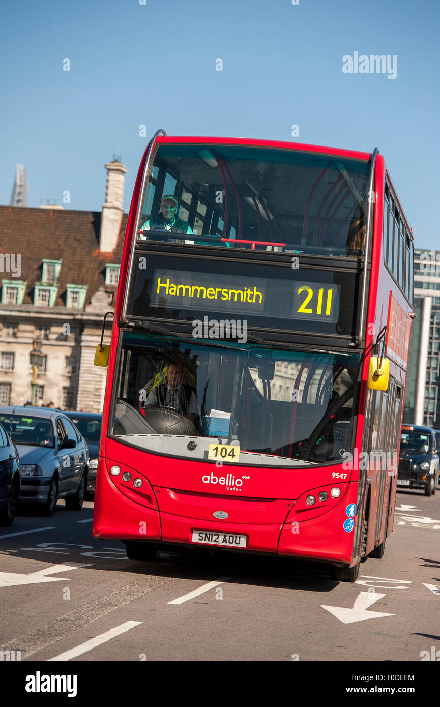 Double decker bus driving along a road in the City of London, England