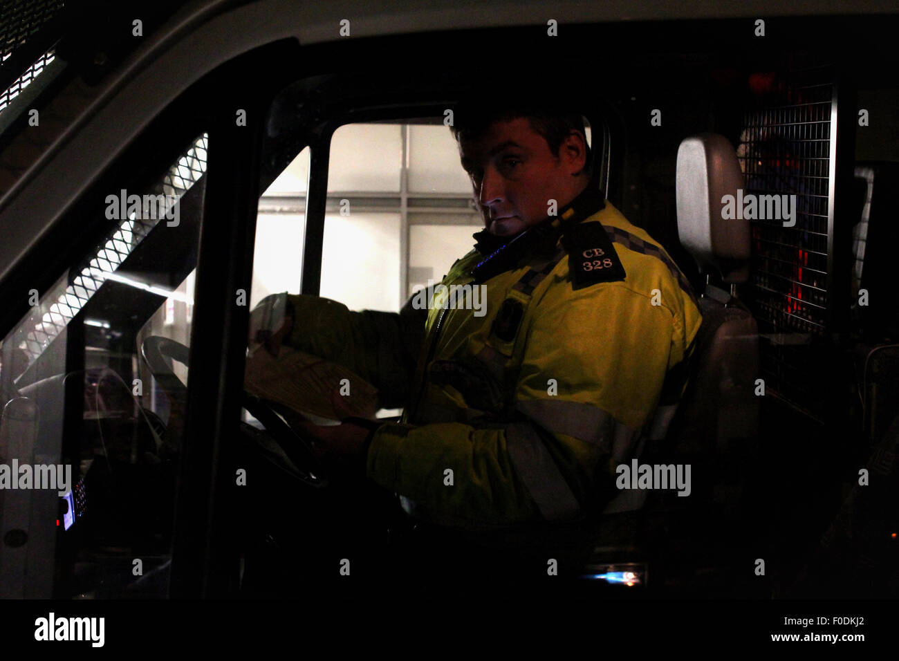 A policeman in a riot van during student protests in Brighton, East Sussex. Stock Photo