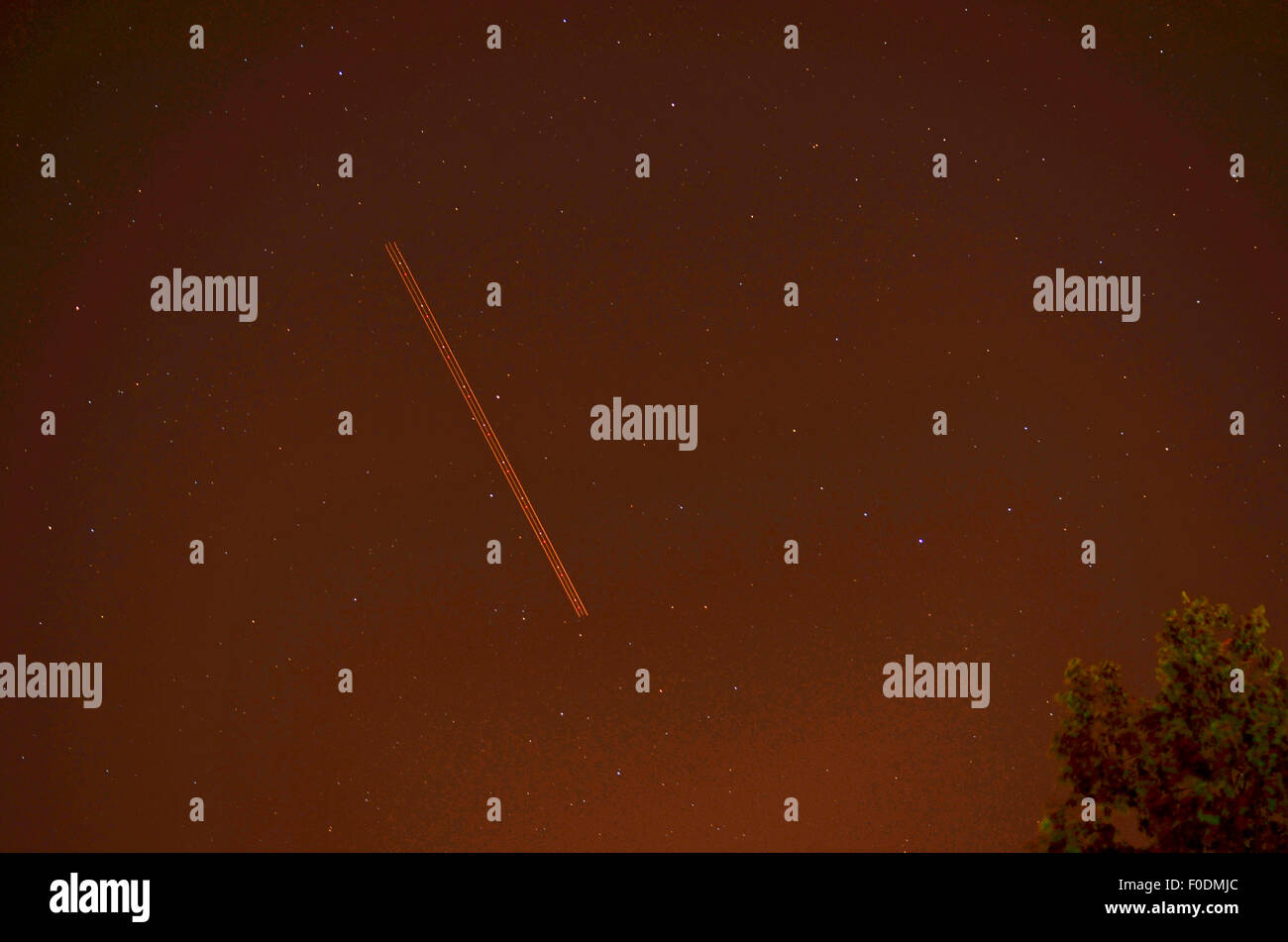 Bristol, UK. 12th Aug, 2015. Plane travels across the night sky during