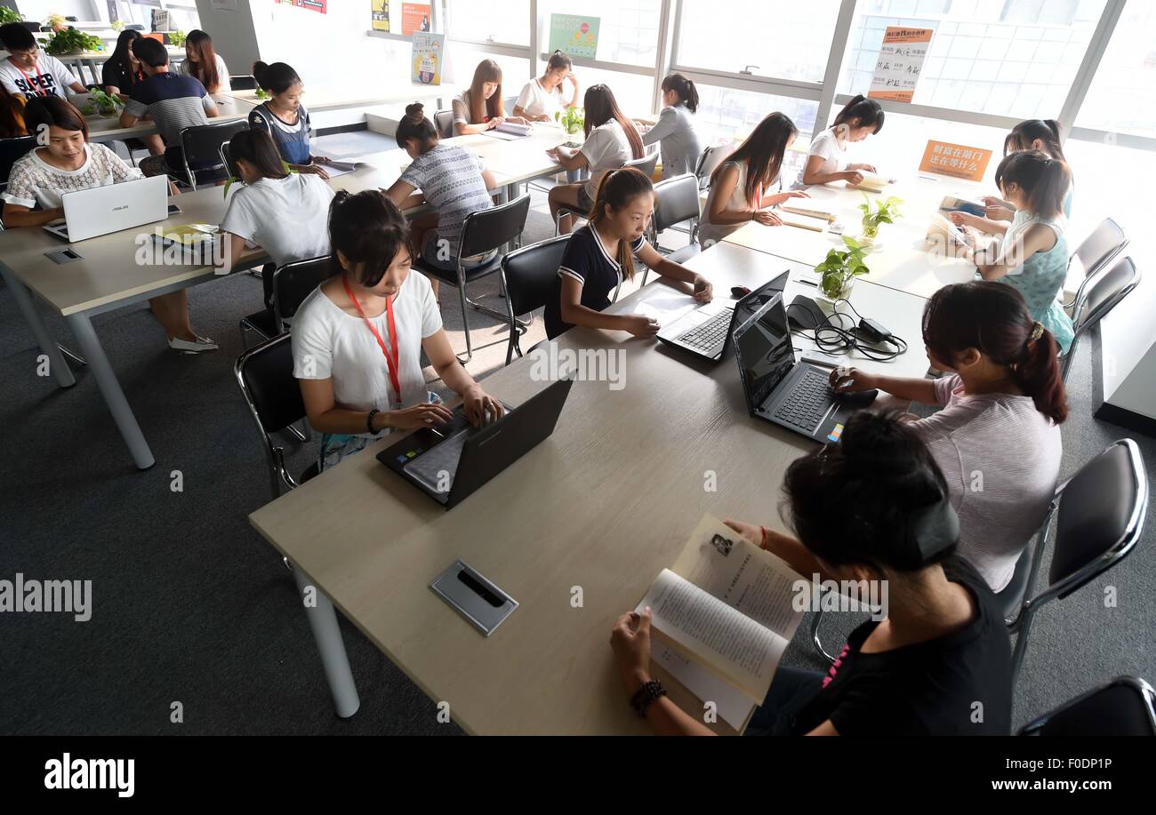 (150813) -- LANGFANG , Aug. 13, 2015 (Xinhua) -- Young people work at 'Qingyun incubator', a business creation agency, in Langfang, north China's Hebei Province, Aug. 13, 2015. The incubator is supported by local government and provides consultation service, office rooms and training program for free to university graduates.(Xinhua/Li Xiaoguo) (xcf) Stock Photo