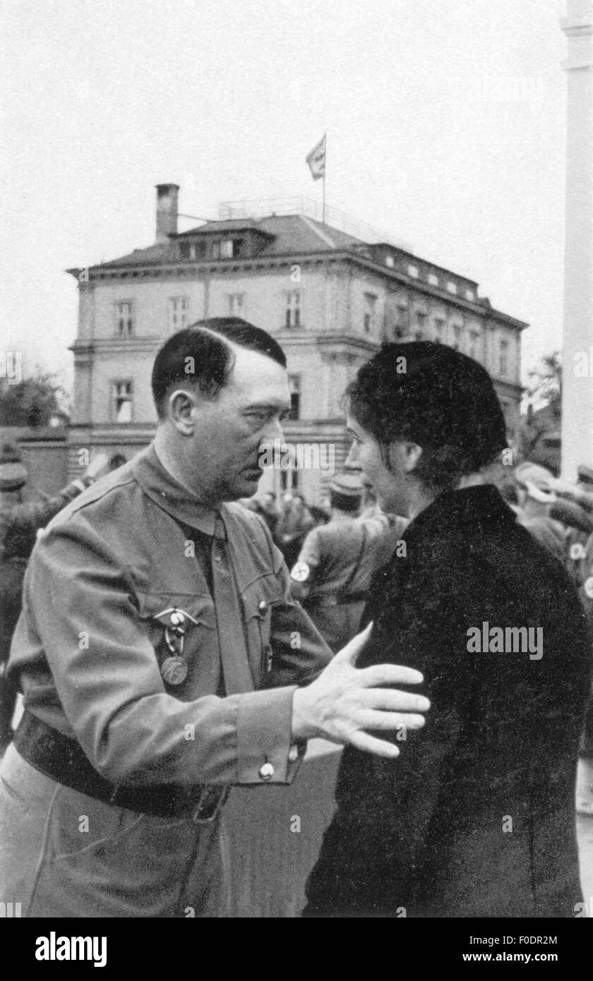 Hitler, Adolf, 20.4.1889 - 30.4.1945, German politician (NSDAP), Chancellor of the Reich 30.1.1933 - 30.4.1945, is talking with the widow of one of the killed men at 9.11.1923, Brienner Strasse, Munich, 9.11.1935, Stock Photo