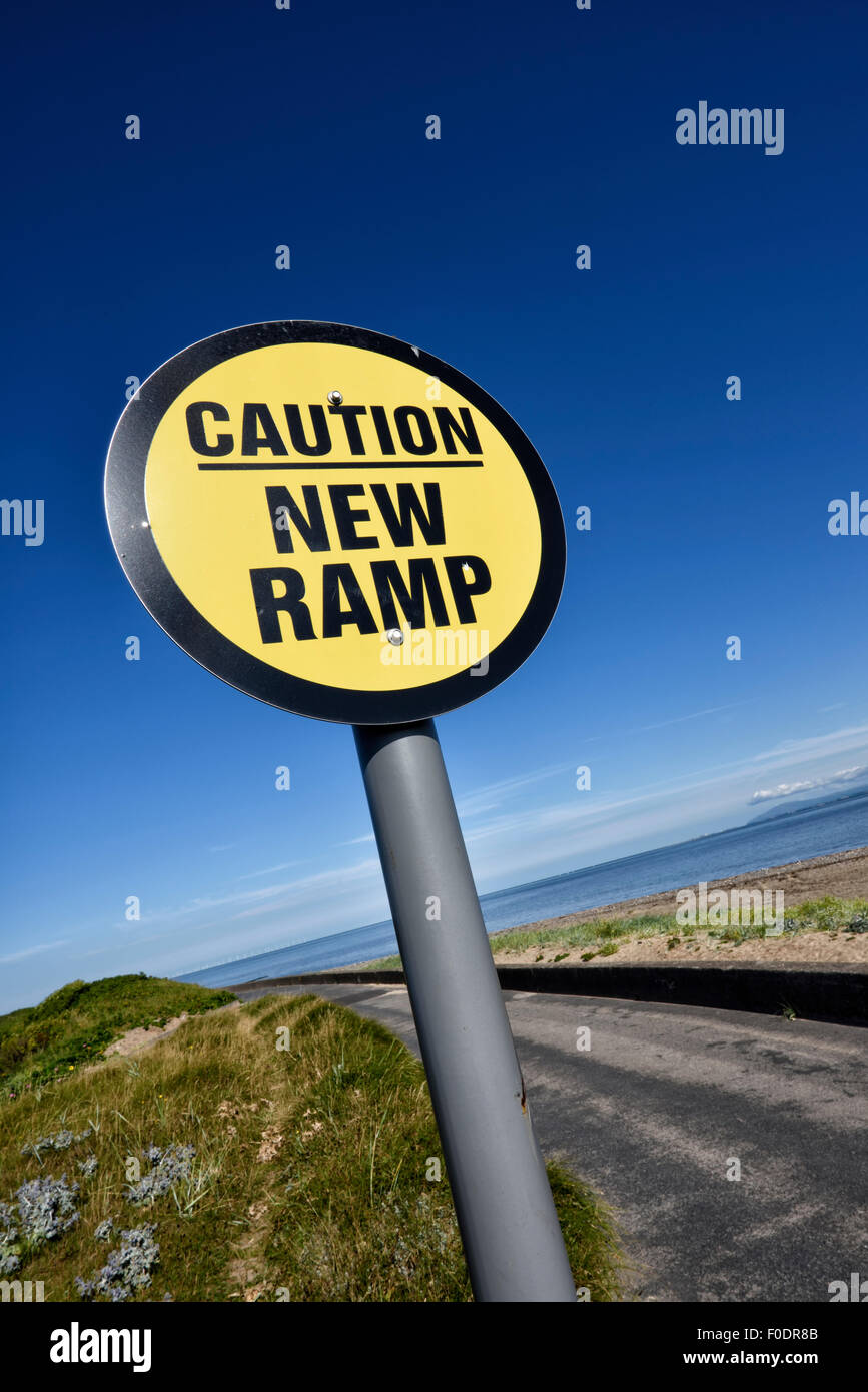 'Caution New Ramp' sign against blue sky Stock Photo