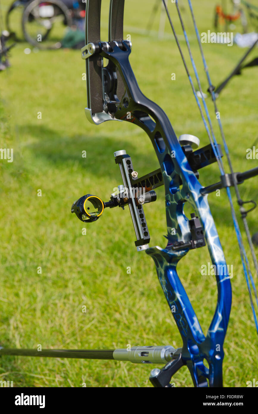 Close-up of compound bow riser or middle handle section with sight while resting on stand during competition Stock Photo