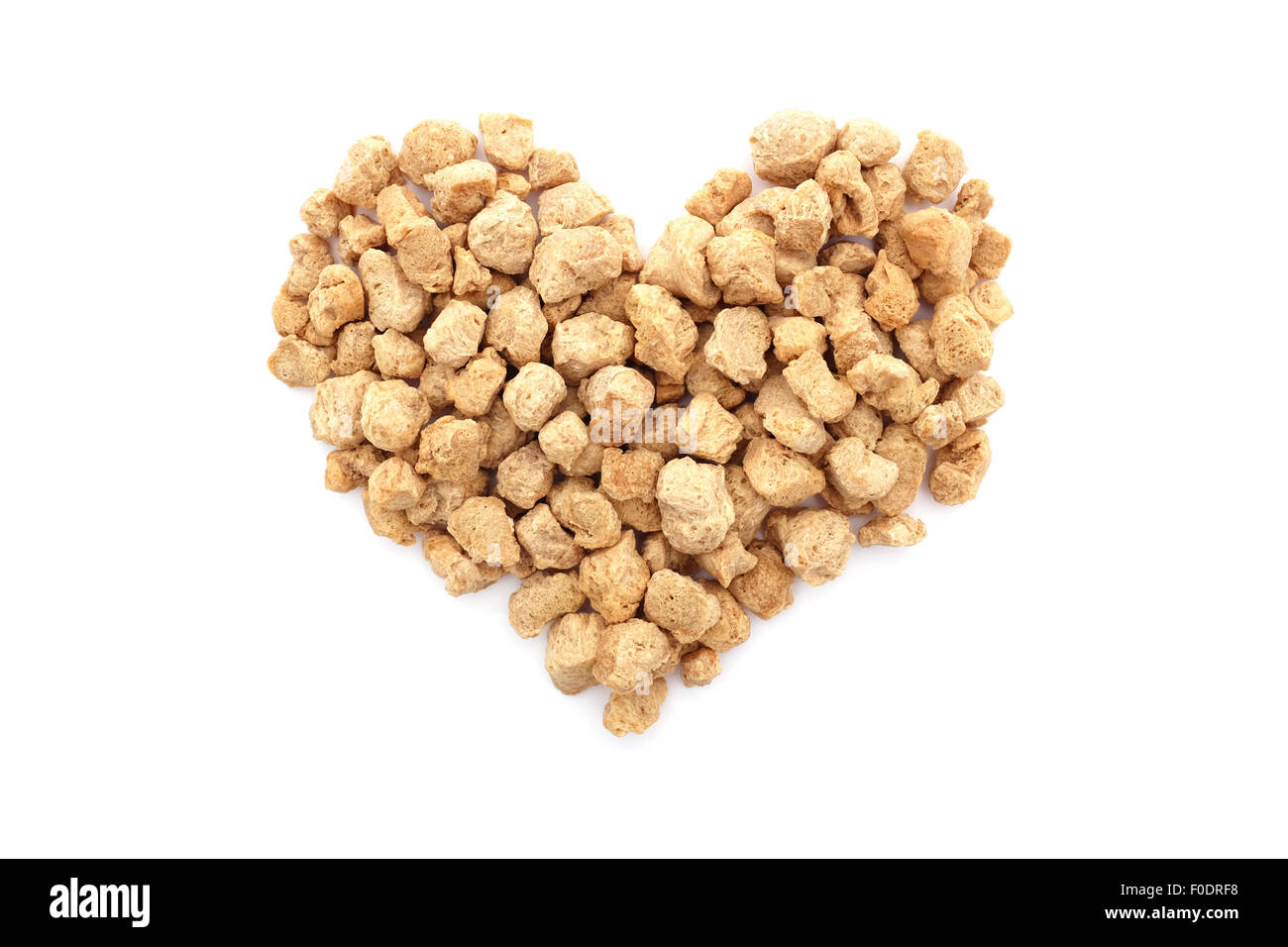Soya protein chunks in a heart shape, isolated on a white background Stock Photo
