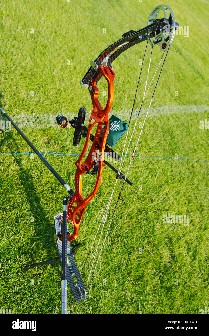 Modern compound archery bow showing eccentric pulleys for levering, the riser and limbs, the sight and stabilizers on stand in f Stock Photo