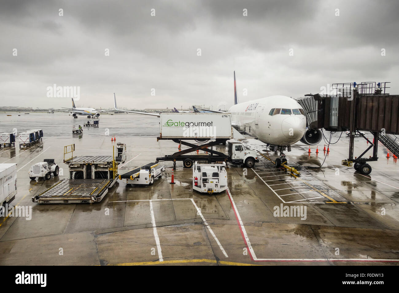 Dark clouded skies at Newark Liberty International Airport, Delta airlines plane, catering service, New Jersey USA. Stock Photo