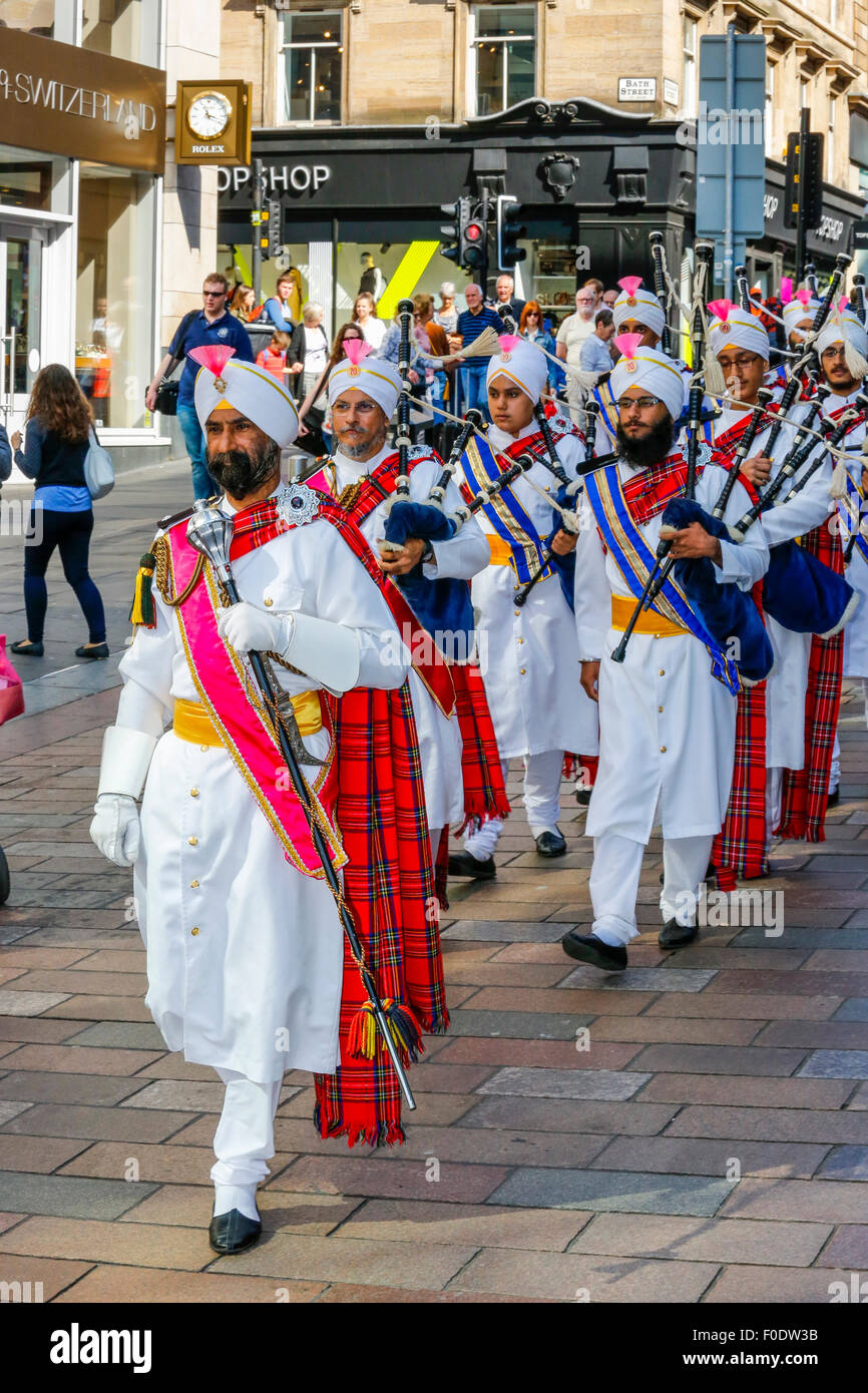 Glasgow, UK, 13th Aug, 2015. At Glasgow's annual Festival of Bagpipe music, "Piping Live", which ends with the World Championship competition on Saturday 15the August, the National Pipe Band of Malaysia - "The Sri Dasmesh Pipe Band" based in Kuala Lumpar, entertained the crowds in Buchanan Street and George Square, by playing a medley of Scottish bagpipe music on a sunny day in Scotland. Credit:  Findlay/Alamy Live News Stock Photo