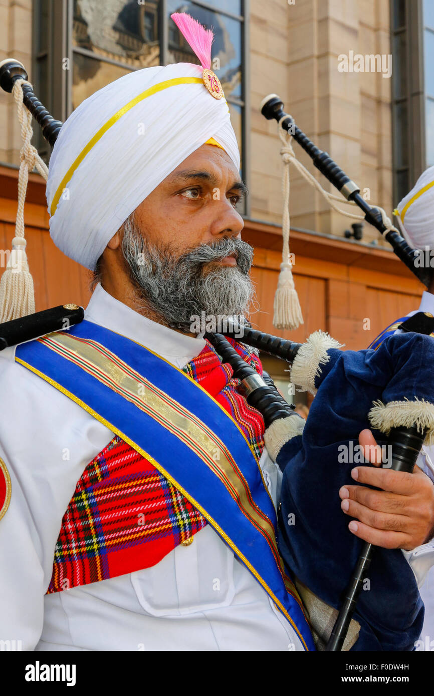 Glasgow, UK, 13th Aug, 2015. At Glasgow's annual Festival of Bagpipe music, 'Piping Live', which ends with the World Championship competition on Saturday 15the August, the National Pipe Band of Malaysia - 'The Sri Dasmesh Pipe Band' based in Kuala Lumpar, entertained the crowds in Buchanan Street and George Square, by playing a medley of Scottish bagpipe music on a sunny day in Scotland. Credit:  Findlay/Alamy Live News Stock Photo