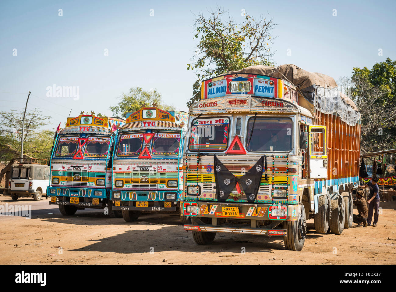Colourfully decorated goods lorries in a layby in Madhya Pradesh, India Stock Photo