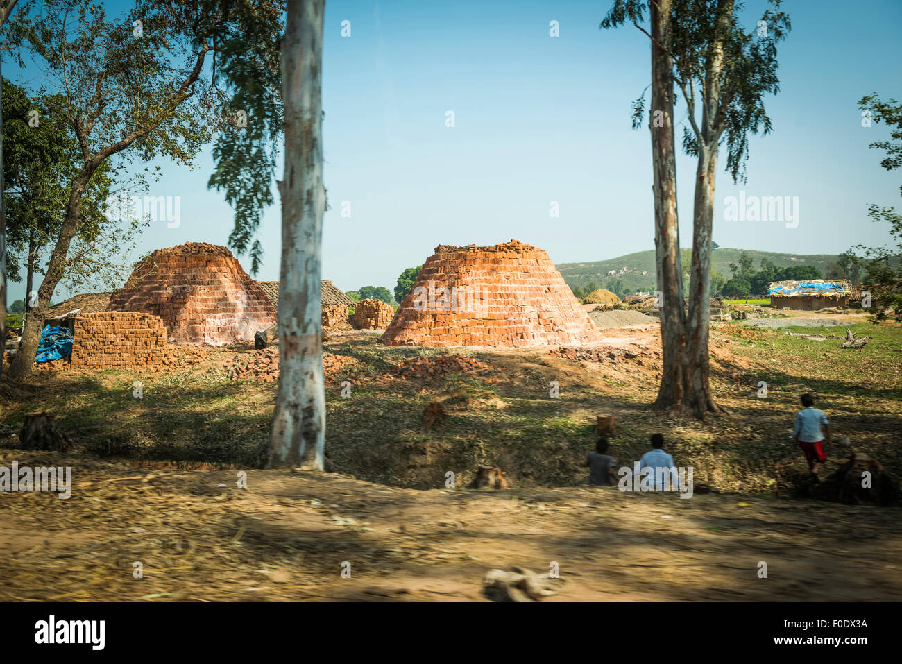 Piles of newly baked bricks waiting to be used along a roadside in India Stock Photo