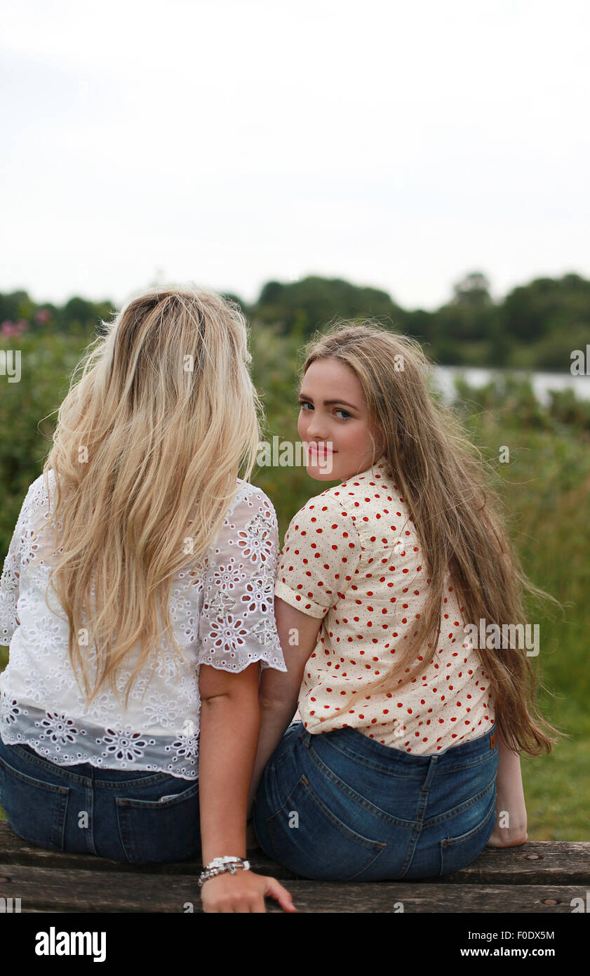 Two teenage girls on looking away and one looking to camera Stock Photo