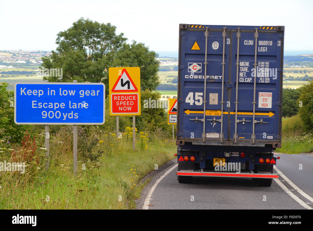 lorry passing emergency escape lane warning sign in case of brake failure on steep hill at staxton scarborough yorkshire uk Stock Photo