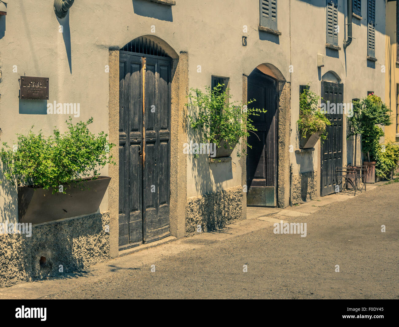 White rendered buildings with wooden doors. Naviglio, Milan, Italy ...