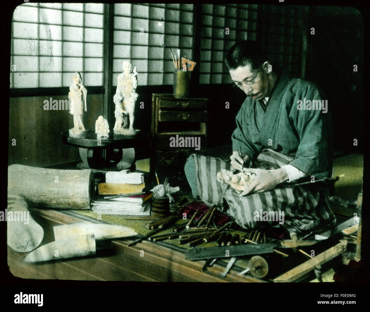 Man carving ivory statue of mother and child Stock Photo Alamy