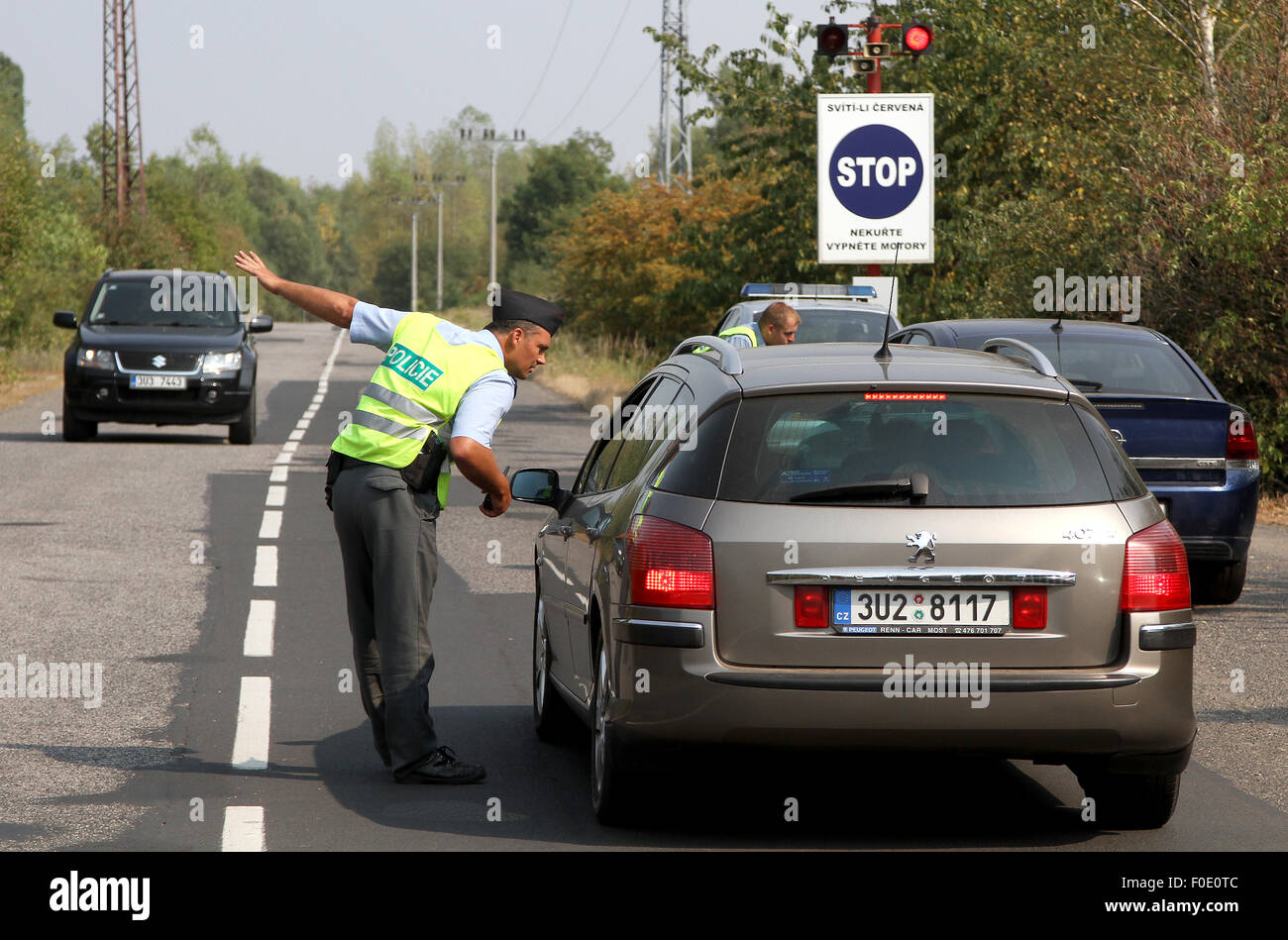 Policeman diverts traffic around Unipetrol petrochemical plant after an explosion of unidentified chemical substance there in Litvinov, 110 kilometres (68 miles) North West of Prague, Czech Republic, on Thursday, August 13, 2015. One injury is reported, employees were evacuated. (CTK Photo/Vojtech Hajek) Stock Photo