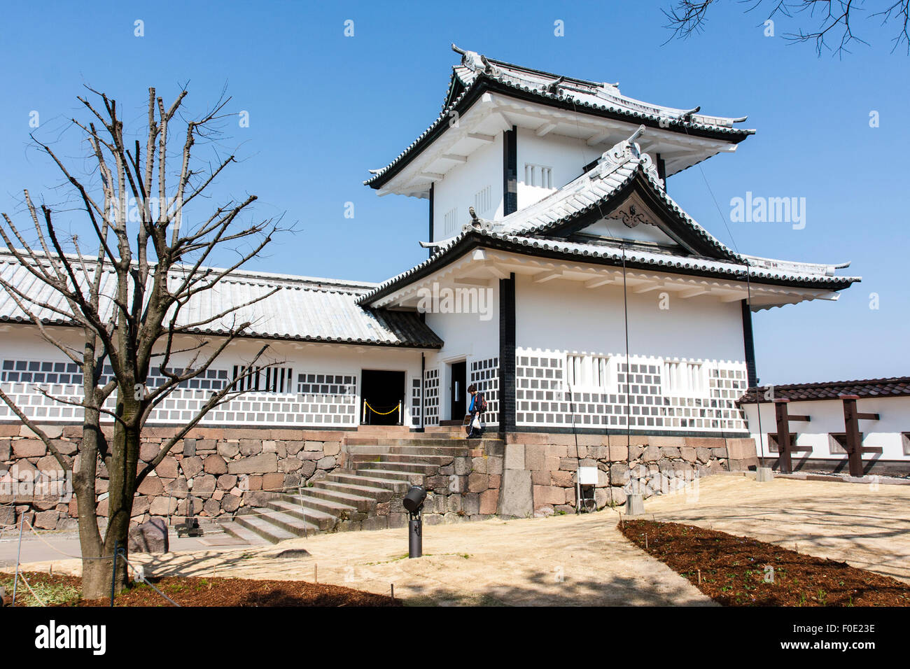 Japan, Kanazawa castle. Two story yagura, turret, part of the Ishikawa-mon gate guarding the bridge entrance into the castle. Blue sky. Stock Photo