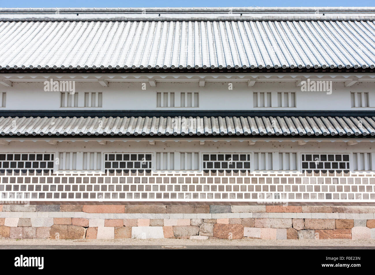 Japan, Kanazawa Castle. Restored Gojikken Nagaya, a two-level turret corridor. Detail of stone base, both floors, roof and firing windows Stock Photo