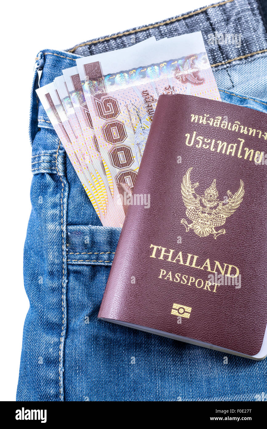 Thai Money 1000 Bath and Thailand passport on blue jeans isolated on white background Stock Photo