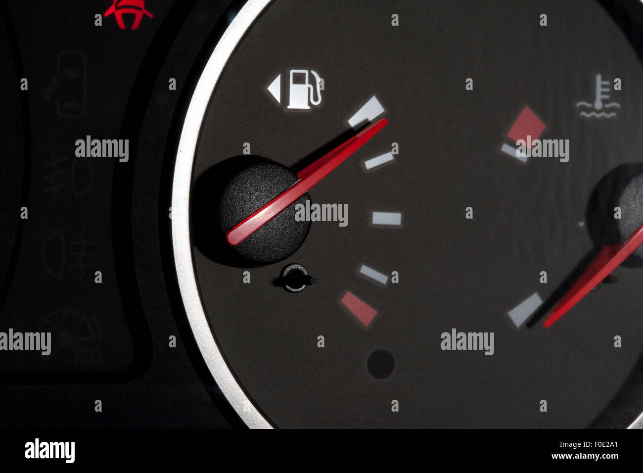 Black fuel gauge with red needles showing full tank Stock Photo Alamy