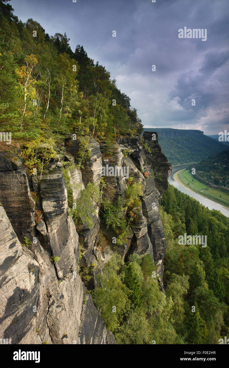 Rock face in forest with Elbe River in valley, Elbe Landscape protected