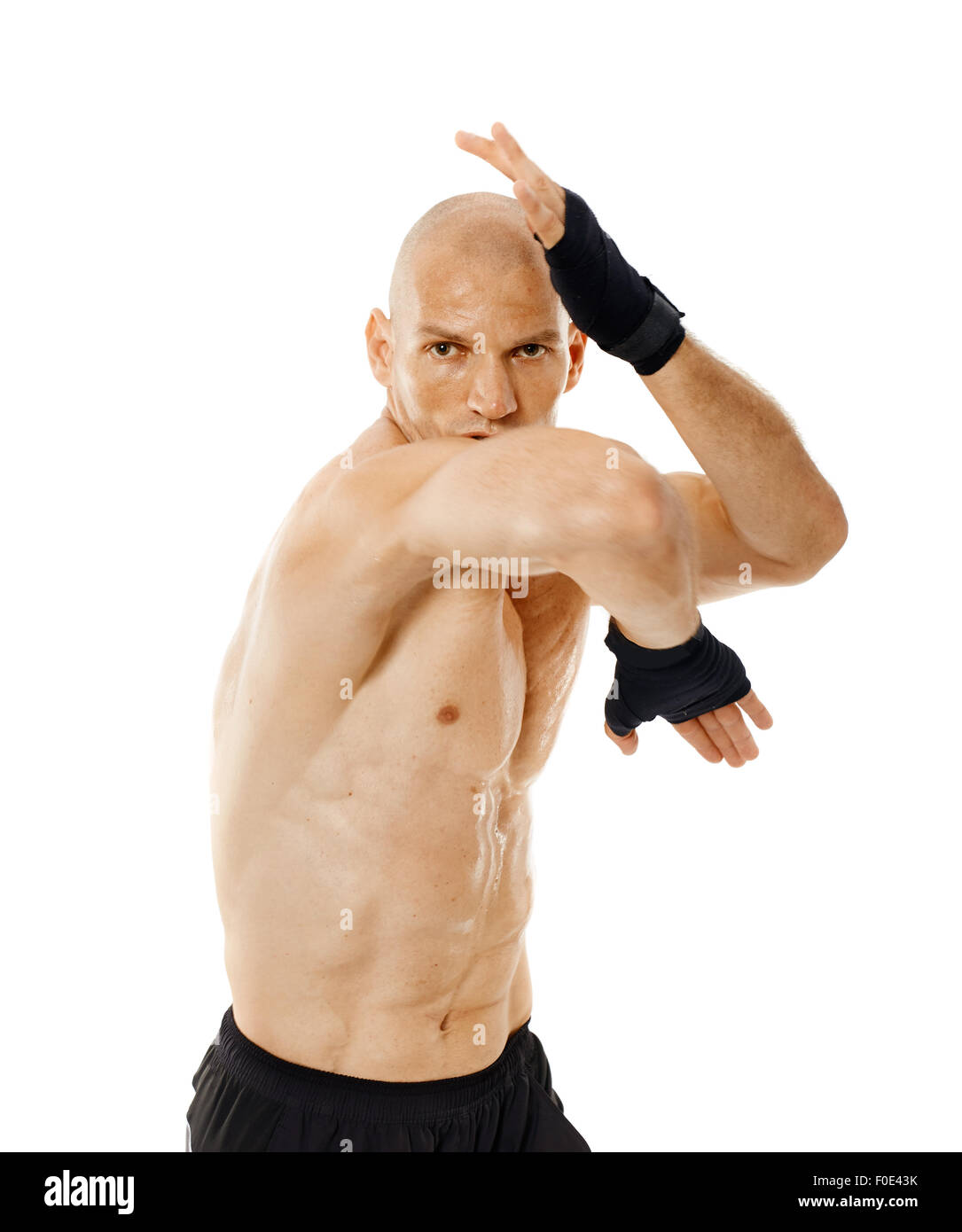 Muay thai fighter delivering an elbow hit isolated on white background