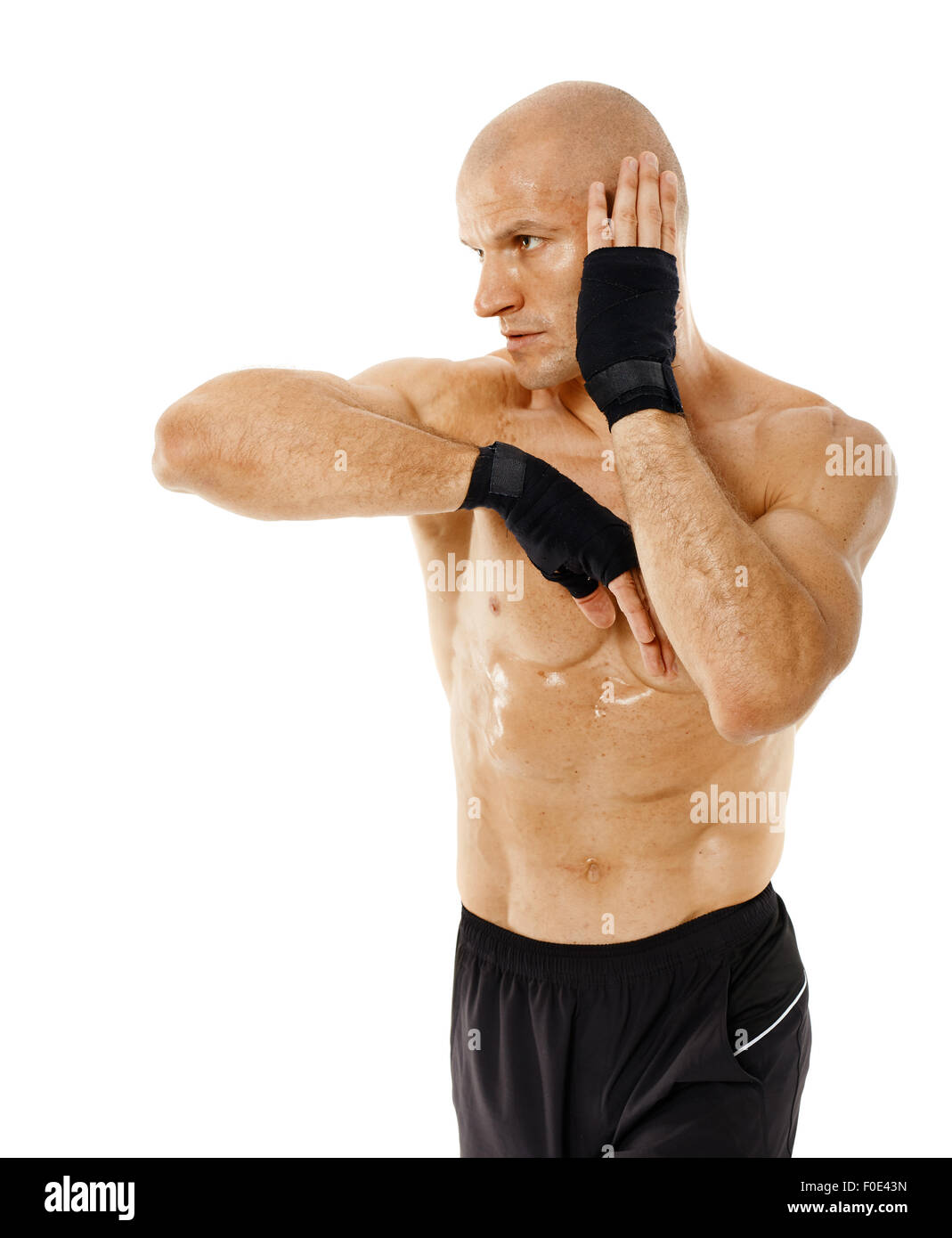Muay thai fighter delivering an elbow hit isolated on white background