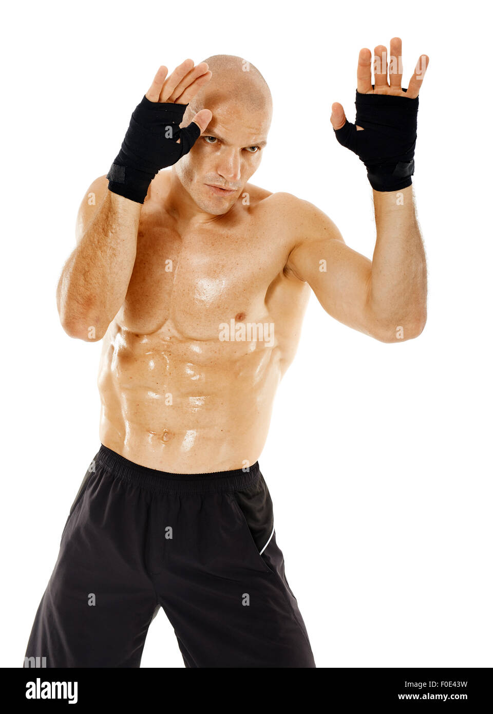 Male muay thai or kickbox fighter in guard stance isolated on white