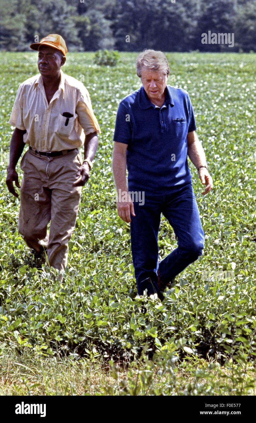Nov. 11, 2014 - President Jimmy Carter and his brother Billy Carter are joined by a tenant farmer as they assess their summer peanut crop. The Carters own tracts of farmland around Plains, Georgia along with a peanut warehouse in that city, although the President's holdings are held in a blind trust during his presidency. (Credit Image: © Ken Hawkins via ZUMA Wire) Stock Photo