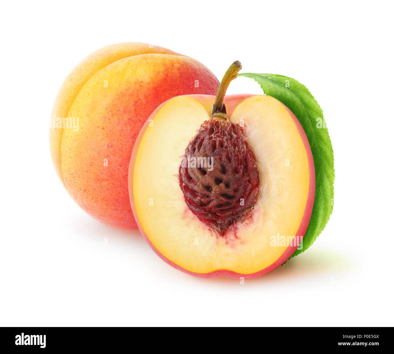 Fresh peaches cut and whole over white background, with clipping path Stock Photo