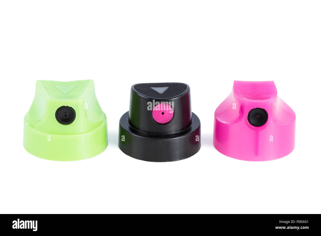 Closeup of three clean colorful spray can nozzles in a row, isolated