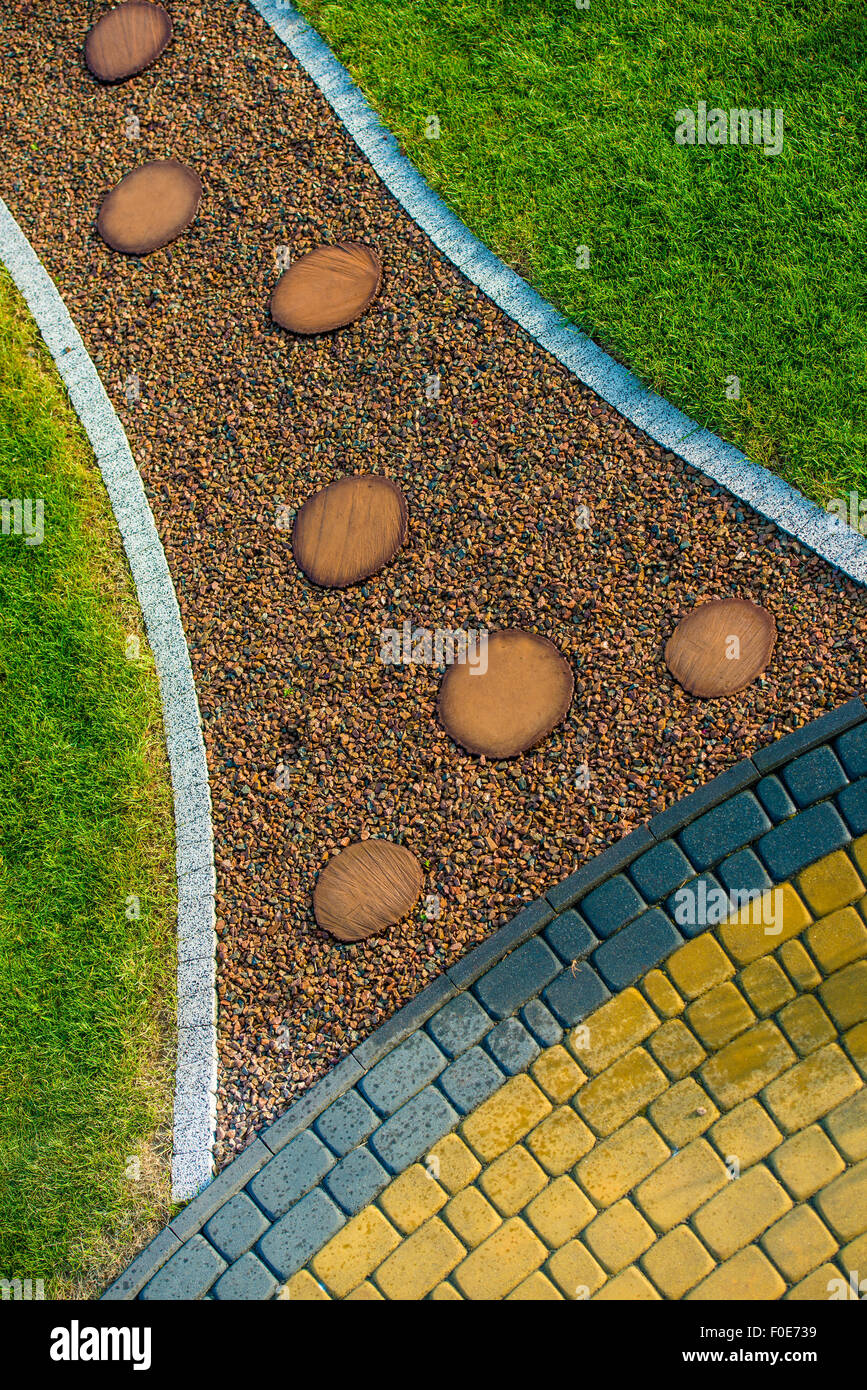 Creative Garden Pathway with Cobblestone Island Closeup Photo. Garden Design. Stock Photo