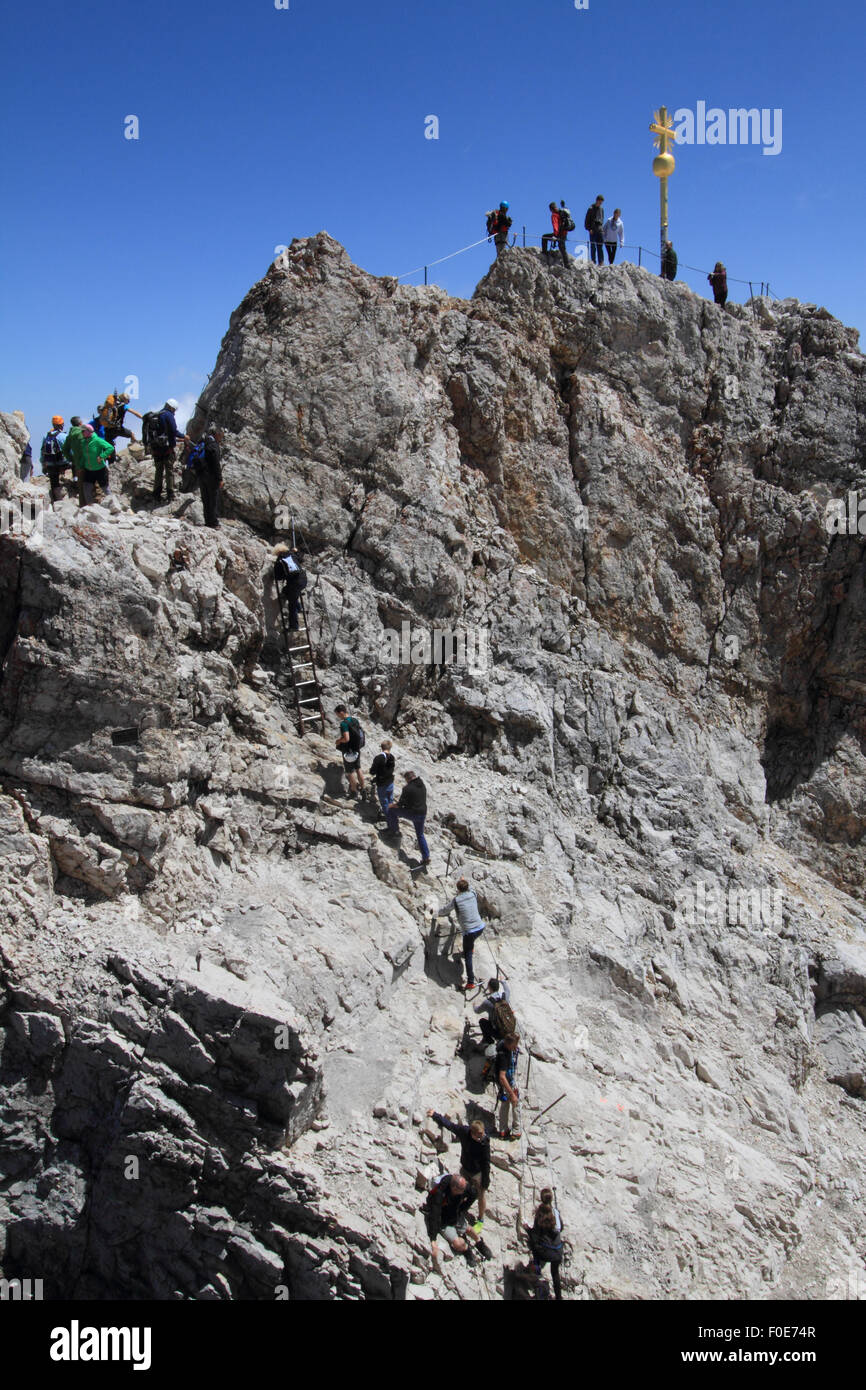 Tourists and climbers at the summit of Zugspitze, the tallest mountain in Germany. Stock Photo