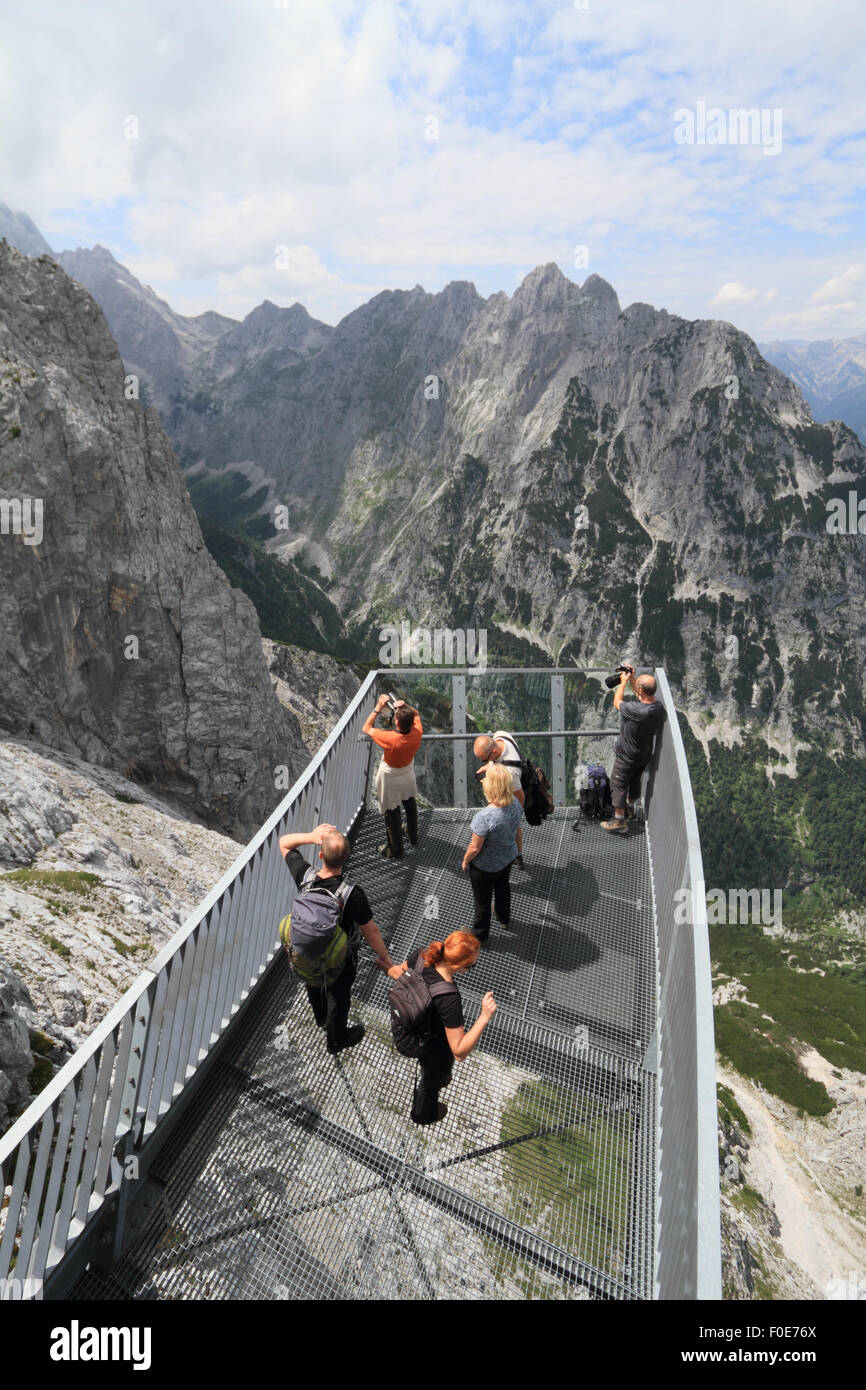 Tourists enjoying the view (and thrilling experience) from the AlpspiX viewing platform at Alpspitze in the alps. Stock Photo