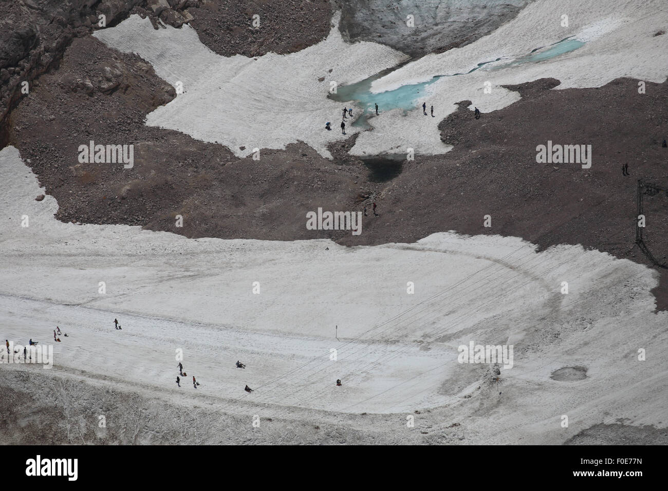 Tourists on the last bits of the Schneeferner glacier at Zugspitze Stock Photo
