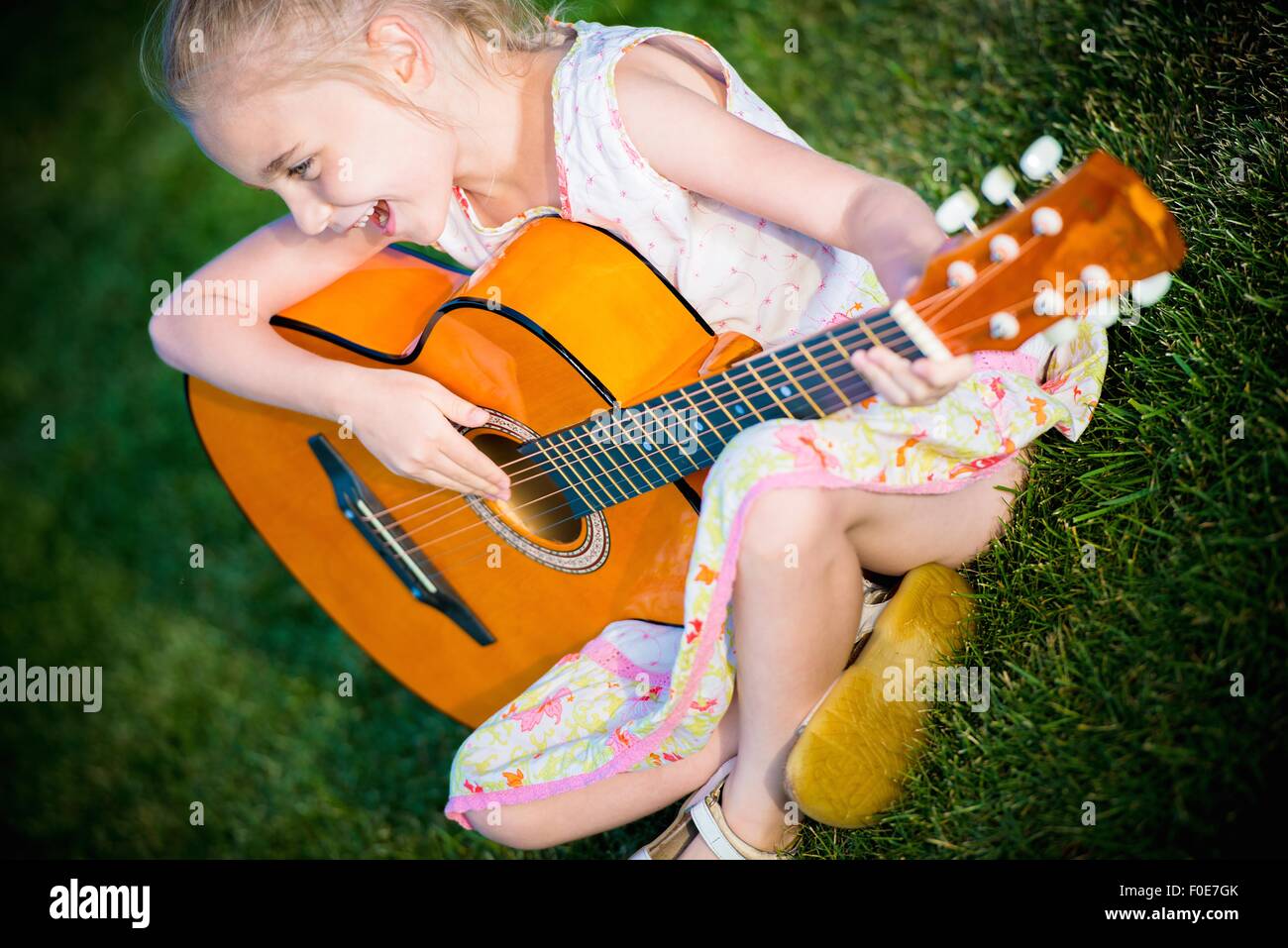 Little Guitar Player Seven Years Old Girl Playing Guitar And Singing