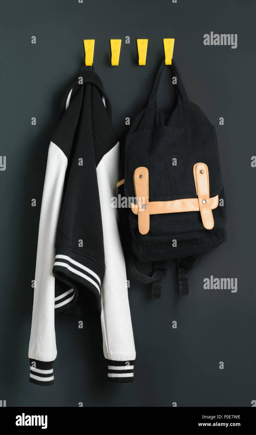 Backpack with books weighs on the wall next to the bomber Stock Photo