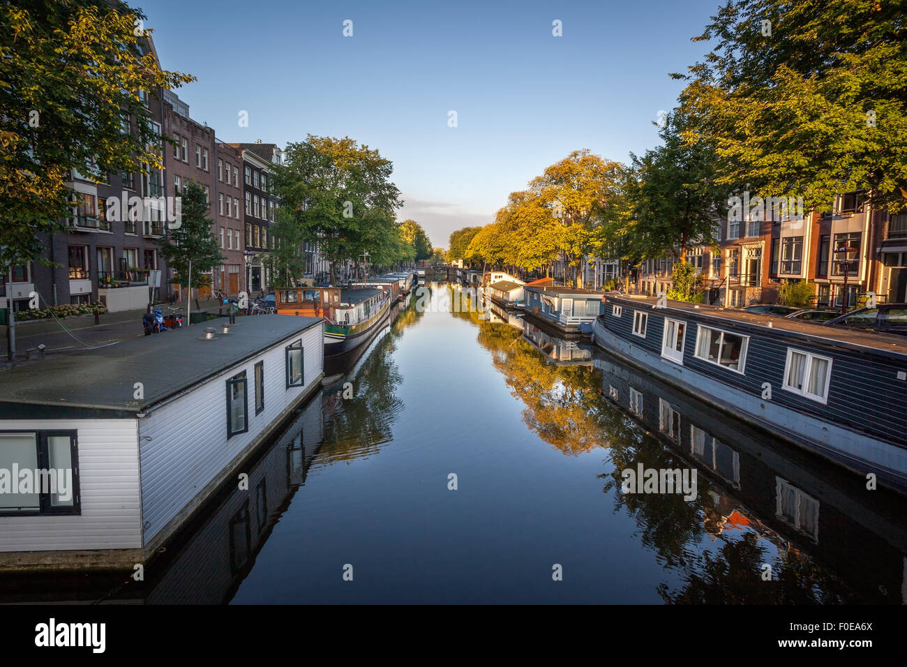 Row of boat house on both side of canal in Amsterdam Netherlands. Stock Photo