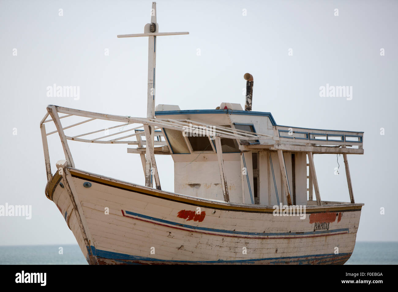 Old wooden fishing boat standing on the beach for repairing works in shipyard. Margarita Island. Venezuela Stock Photo