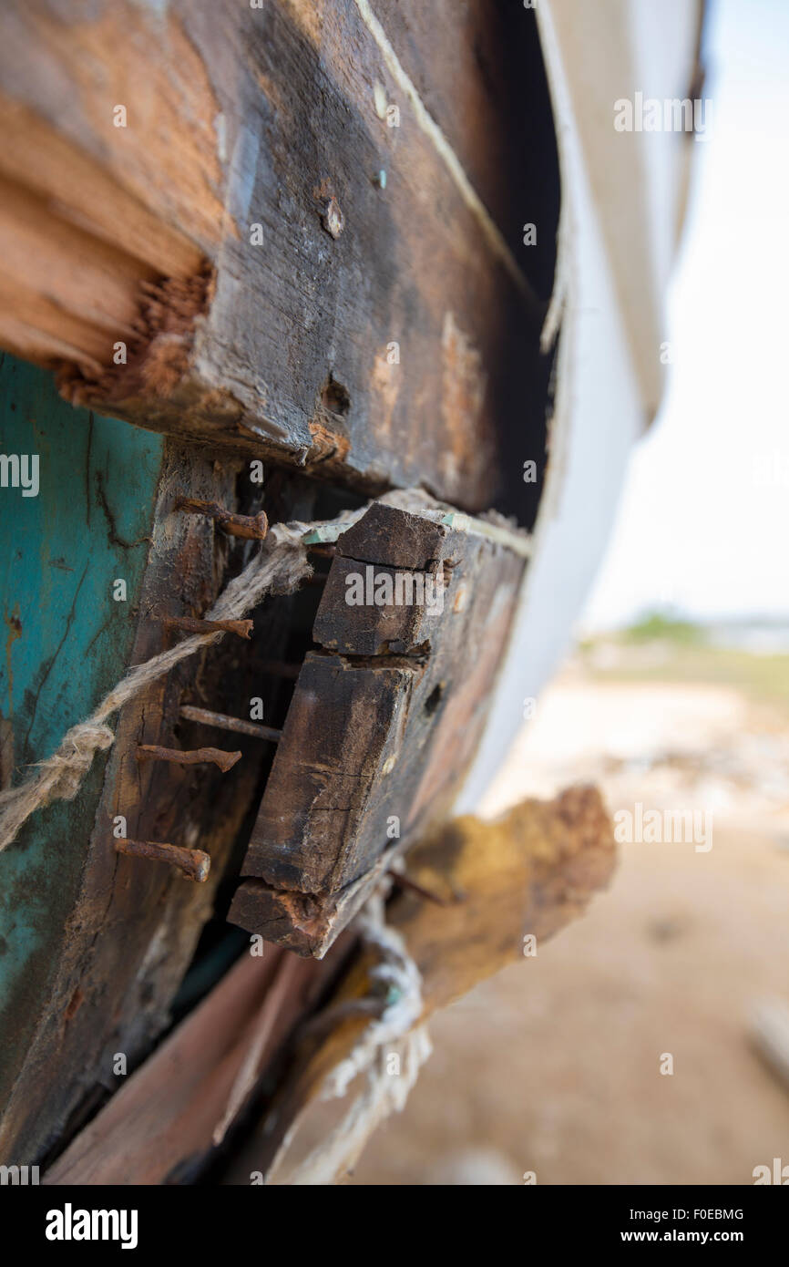 Detail of old shipwreck with remains of nails in wooden boards with faded paintings. Margarita Island. Venezuela Stock Photo